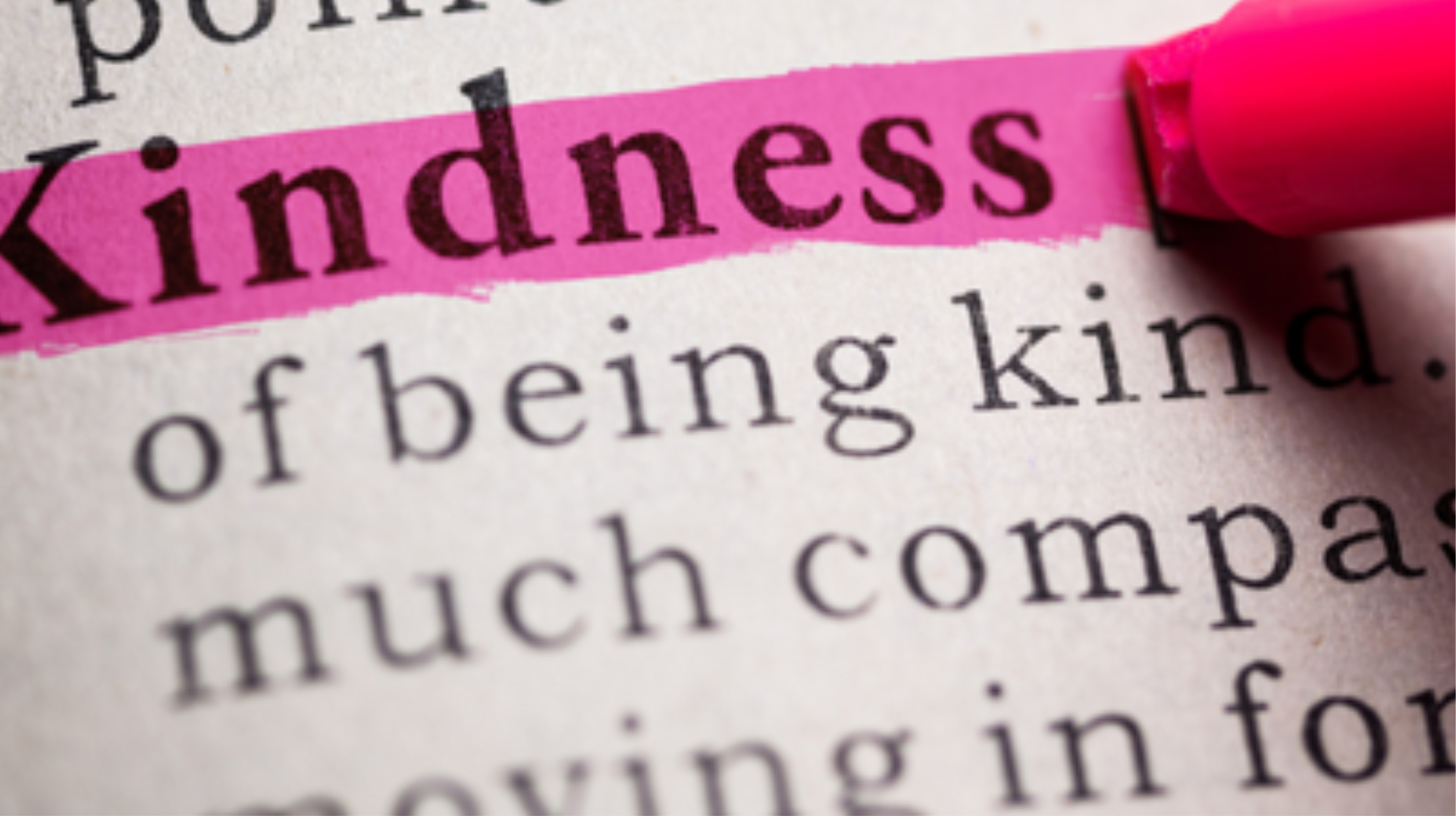The word 'kindness' being highlighted in a dictionary